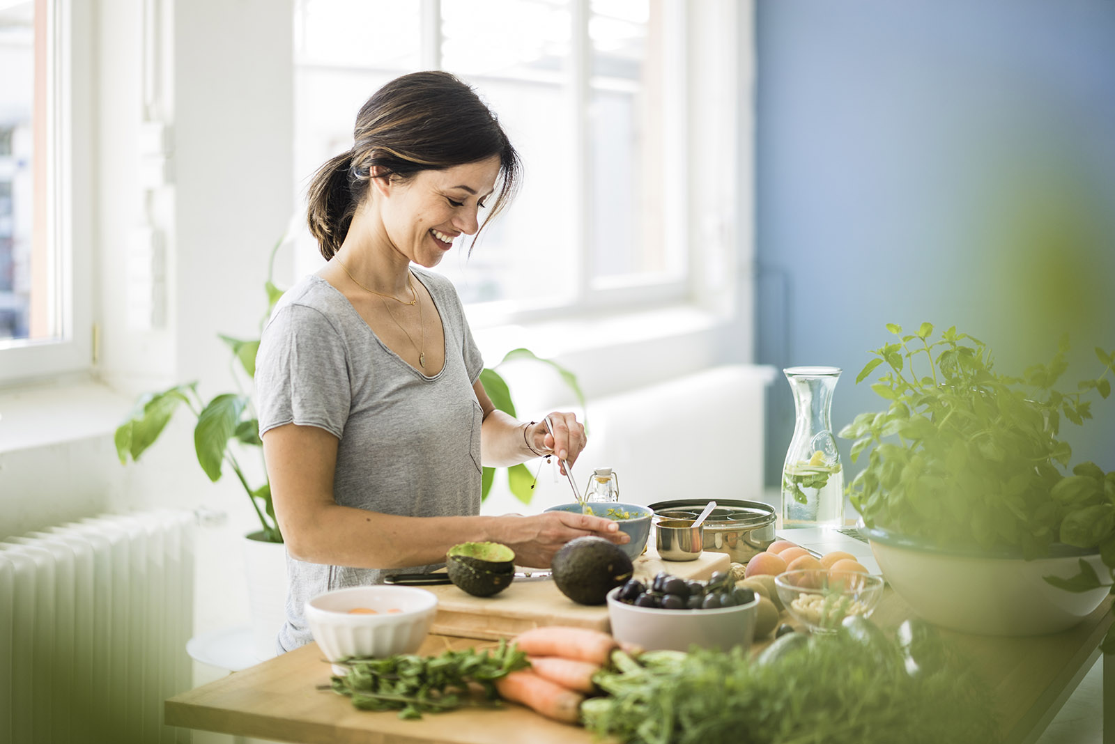 Woman preparing healthy food in her kitchen